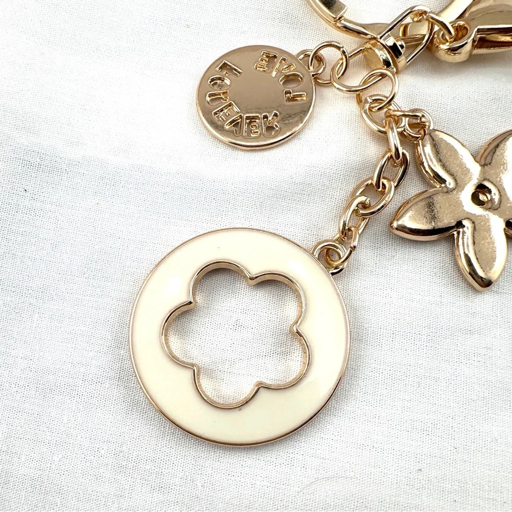 Unbranded keychain or purse charm. Gold and black. NEW.